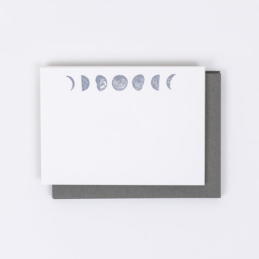 Set of 10 Letterpress Note Cards featuring hand-drawn Moon Phases letterpress printed in a shimmery silver ink onto 100% cotton paper. Includes 10 rich grey envelopes. Size A6.