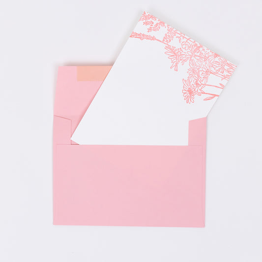 Set of 10 Letterpress Note Cards featuring a hand-drawn Wildflower Bouquet letterpress printed in a soft pink ink onto 100% cotton paper. Includes 10 soft pink envelopes. Size A6. The cards are stacked on the envelopes shown on a white background.