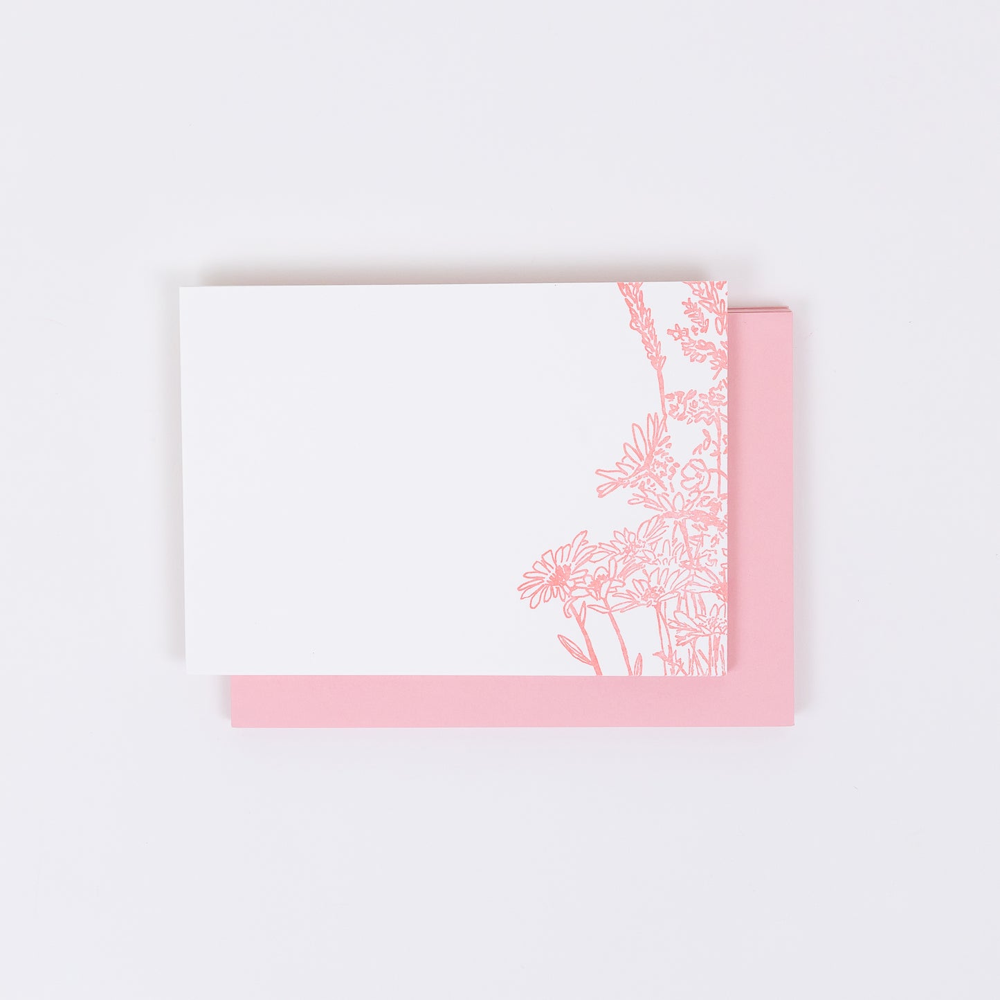 Set of 10 Letterpress Note Cards featuring a hand-drawn Wildflower Bouquet letterpress printed in a soft pink ink onto 100% cotton paper. Includes 10 soft pink envelopes. Size A6. The cards are stacked on the envelopes shown on a white background.