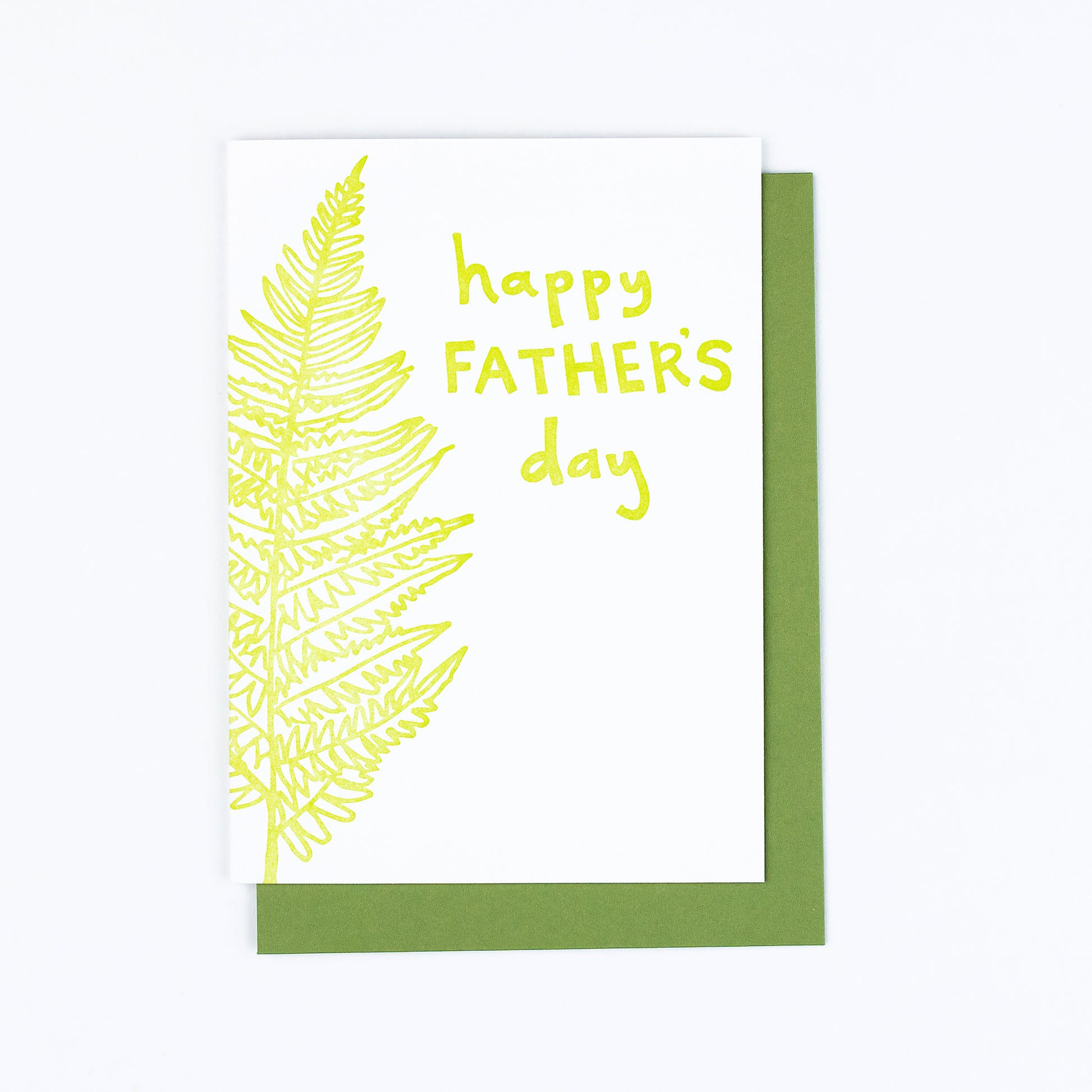 Letterpress greeting card featuring a hand-drawn fern, printed in a vibrant lime green ink. The top right of the card says "Happy Father's Day" in a whimsical hand-drawn text, in the same lime green ink. The card is white, blank inside, and is paired with a green envelope.