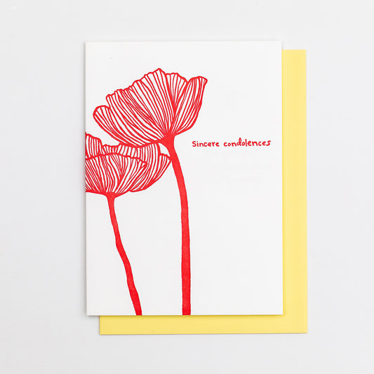 Letterpress greeting card featuring an intricate hand-drawn poppy flower, printed in a vibrant red ink ink. Whimsical hand-drawn text saying "Sincere Condolences" is shown on the right of the card, in the same red ink. The card is white, blank inside, and is paired with a soft yellow envelope.