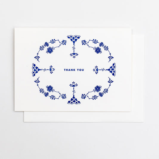 Letterpress greeting card featuring hand-drawn Furnivals Denmark Blue china pattern design, printed in a vibrant royal blue ink. Text saying "thank you" is shown centered on the card, in the same blue ink. The card is white, blank inside, and is paired with a white cotton envelope. Design is similar to Royal Copenhagen. 