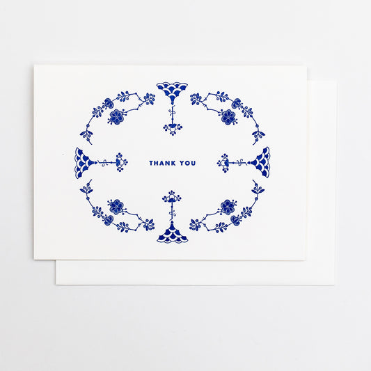 Letterpress greeting card featuring hand-drawn Furnivals Denmark Blue china pattern design, printed in a vibrant royal blue ink. Text saying "thank you" is shown centered on the card, in the same blue ink. The card is white, blank inside, and is paired with a white cotton envelope. Design is similar to Royal Copenhagen.