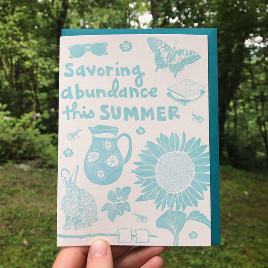 Celebrate SUMMER with this festive greeting card! This cheerful card features all the iconic images of the summer: sunglasses, marigolds, swallowtail butterfly, store, lightning bug / firefly, sunflower, lemonade, basil, bunny rabbit, marshmallows on a stick. Hand-drawn images and typography are letterpress-printed in light turquoise blue ink (color varies from card to card). The interior is blank. This single greeting card includes a deep turquoise envelope.