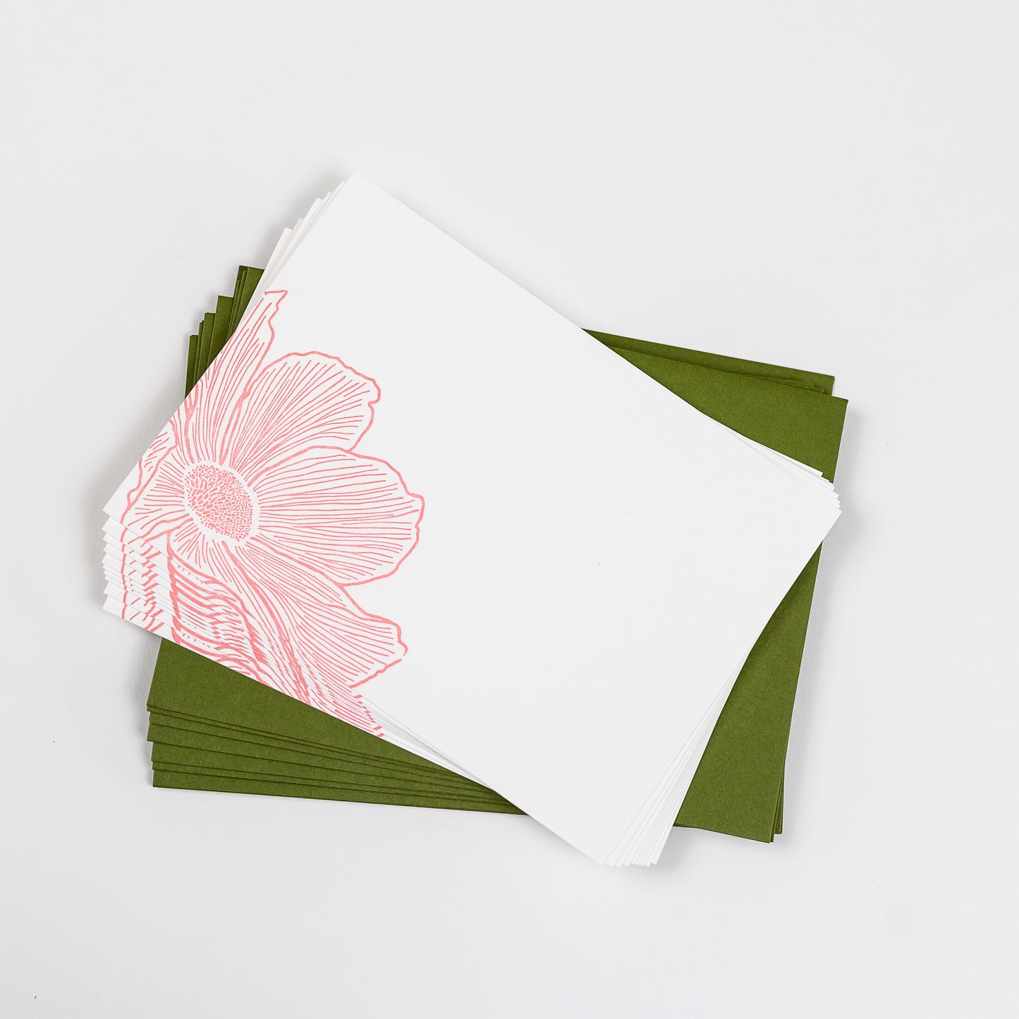Set of 10 Letterpress Note Cards featuring a hand-drawn cosmos flower, letterpress printed in a soft peachy-pink ink onto 100% cotton paper. Includes 10 rich green envelopes. Size A6.  