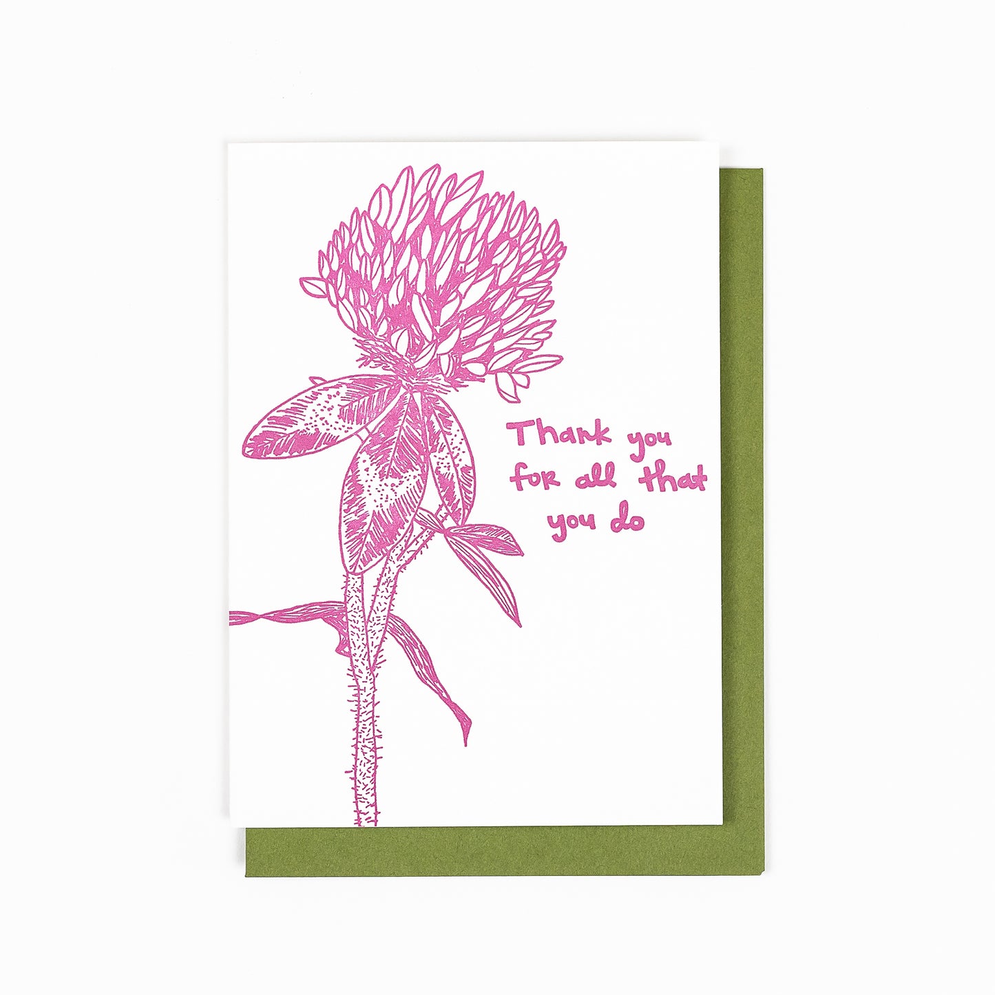 Letterpress greeting card featuring a hand-drawn red clover wildflower, printed in a rich pink ink. Whimsical hand-drawn text saying "Thank you for all that you do" is shown on the right side of the card, in the same pink ink. The white card is 100% cotton, blank inside, and is paired with an earthy green envelope.