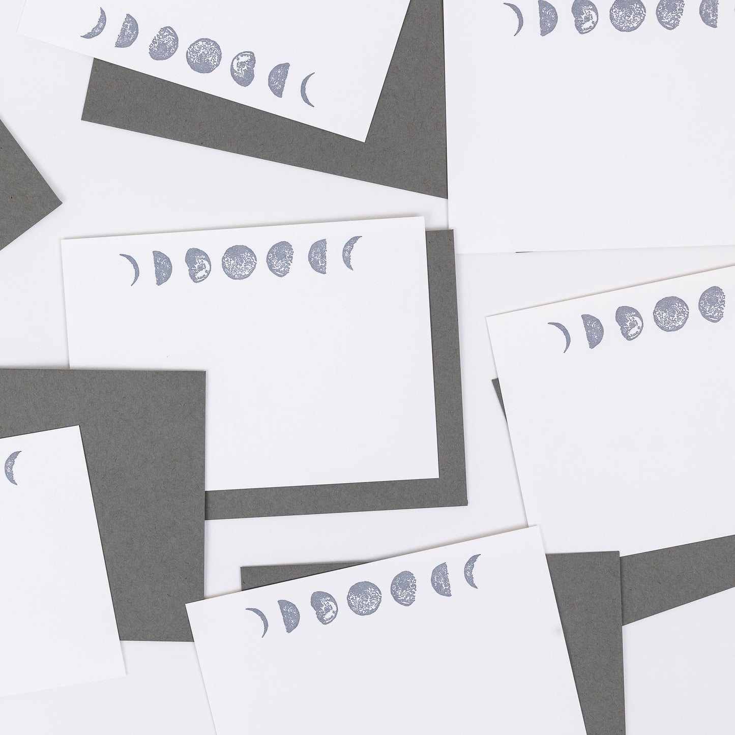 Set of 10 Letterpress Note Cards featuring hand-drawn Moon Phases letterpress printed in a shimmery silver ink onto 100% cotton paper. Includes 10 rich grey envelopes. Size A6. 