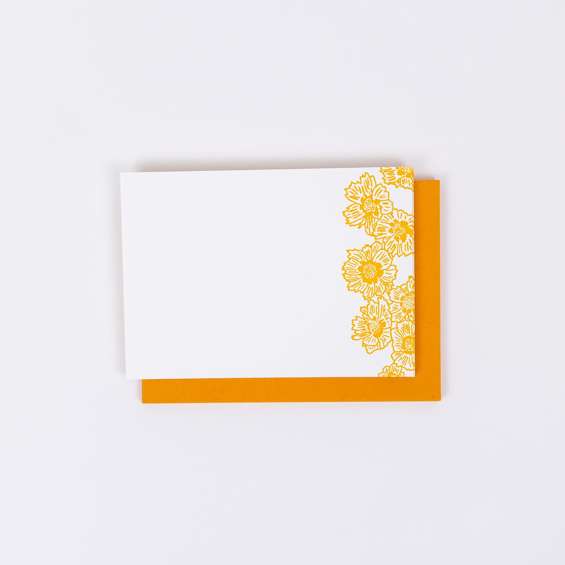 Set of 10 Letterpress Note Cards featuring hand-drawn Coreopsis Flowers letterpress printed in a vibrant golden orange ink onto 100% cotton paper. Includes 10 bright orange envelopes. Size A6.  The cards are stacked on the envelopes shown on a white background.